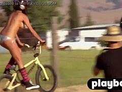 Una chica de trasero grande posa al aire libre en un video de sexo lésbico